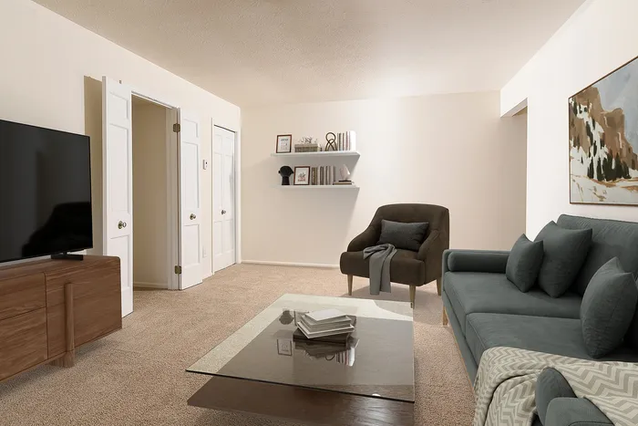 Inviting living room with plush seating, elegant glass coffee table, and modern decor, perfect for relaxation and entertainment.