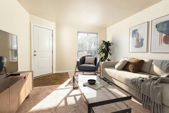 Bright and inviting living room with a cozy beige sofa, modern decor, and ample natural light.