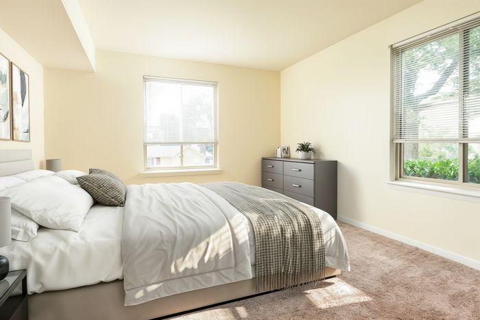 Inviting bedroom with modern design, featuring a cozy bed, soft natural light, and stylish decor.