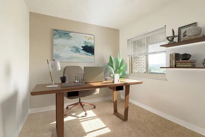 Modern home office featuring a sleek wooden desk, stylish chair, vibrant artwork, and lush greenery by the window.