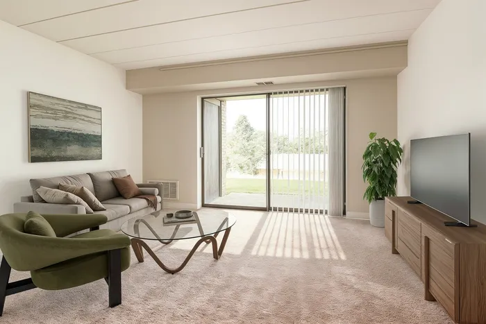 Bright and spacious living room with modern decor, cozy seating, and a sleek glass coffee table, featuring floor-to-ceiling windows and lush outdoor views.