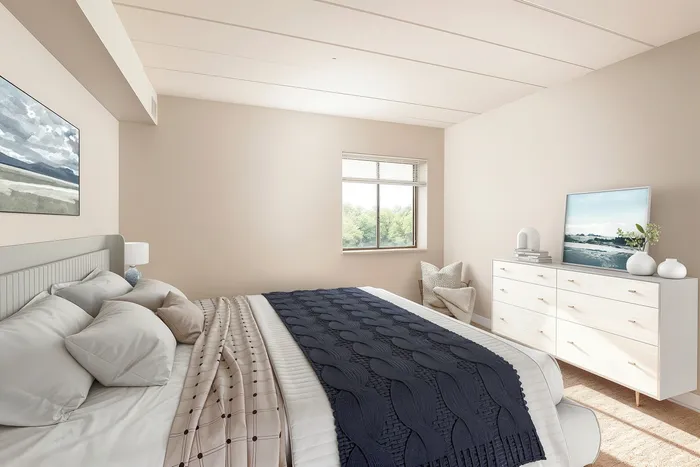 Bright and inviting bedroom with modern decor, featuring a cozy bed, elegant dresser with art and plants, and a window with lush green views.