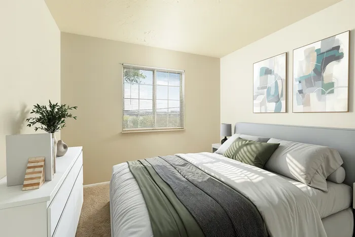 Inviting bedroom with a cozy bed, elegant decor, and a sunlit window creating a warm, serene atmosphere.