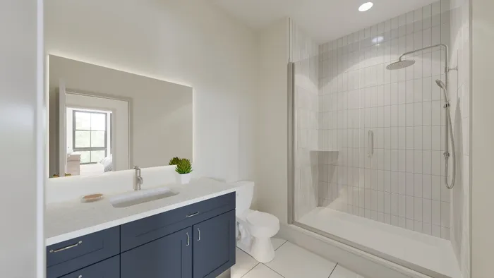 Modern bathroom showcasing a sleek glass shower, elegant cabinetry, and bright natural light enhancing a serene atmosphere.