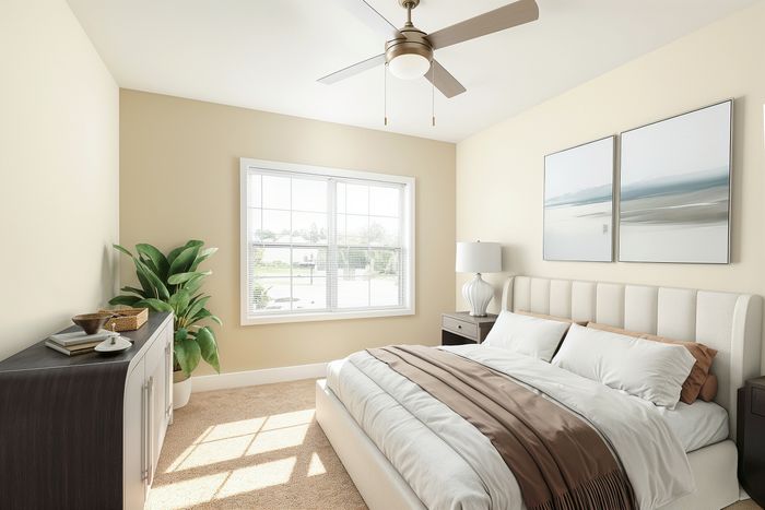 Bright and airy bedroom with elegant decor, featuring a cozy bed, modern ceiling fan, and large window with scenic views.