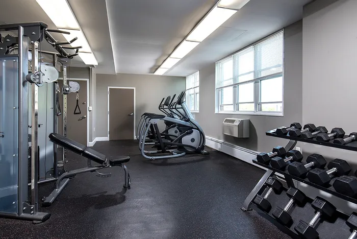 Modern fitness center with state-of-the-art gym equipment, bright windows, and sleek design, perfect for a refreshing workout.