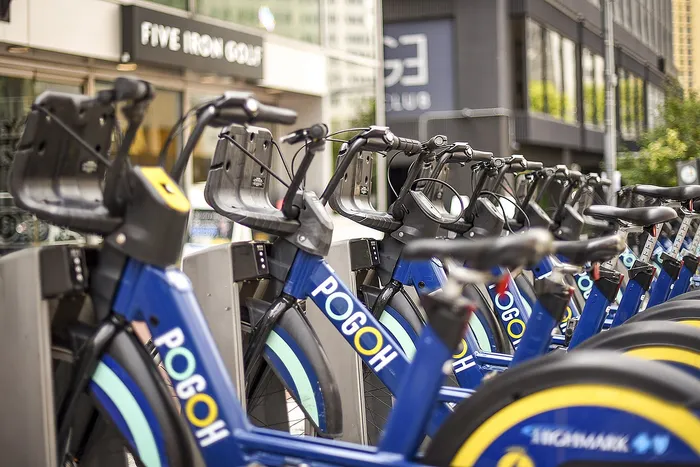 Vibrant urban bike rental station with a row of modern blue bikes ready for adventure.