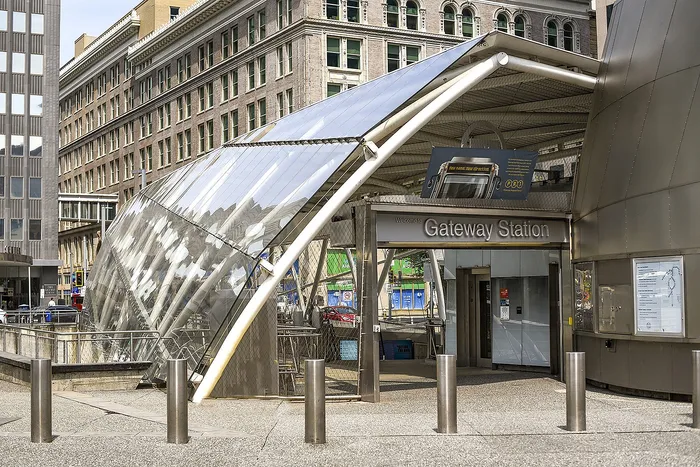 Modern Gateway Station entrance with sleek architectural design and reflective glass canopy in an urban setting.