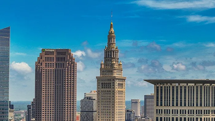 Stunning city skyline featuring iconic skyscrapers against a vibrant blue sky, offering breathtaking urban views.