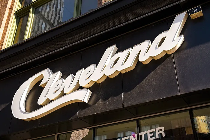 Chic storefront with bold 'Cleveland' sign, showcasing urban charm and modern design.