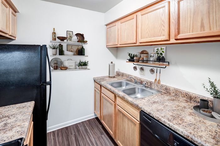 Charming modern kitchen with elegant wooden cabinets, sleek countertops, and stylish open shelving for a cozy and functional space.