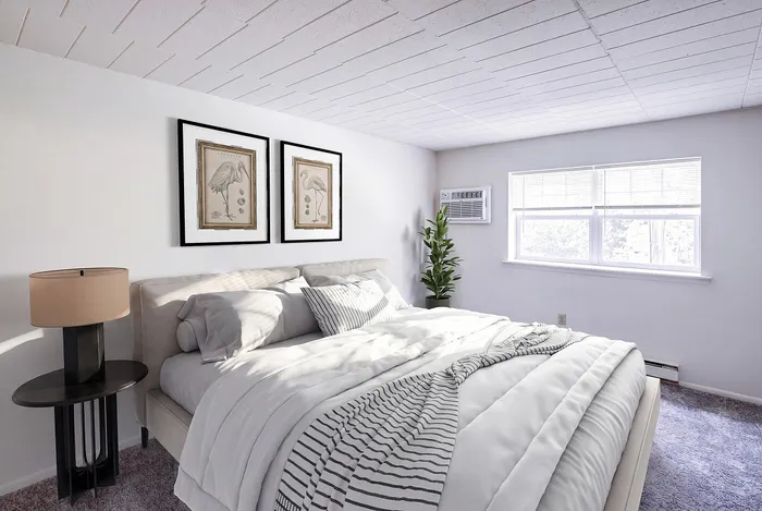Bright and inviting bedroom featuring a plush bed, stylish wall art, and abundant natural light.