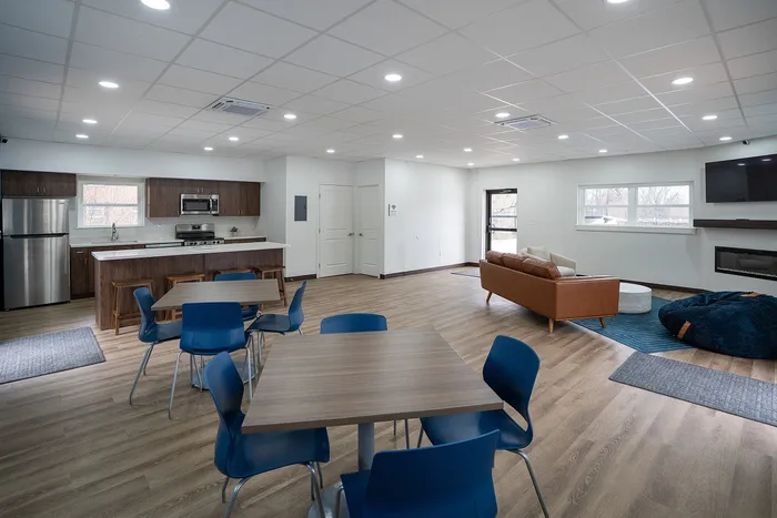 Inviting open-concept living area with modern kitchen, cozy seating, and ample natural light.