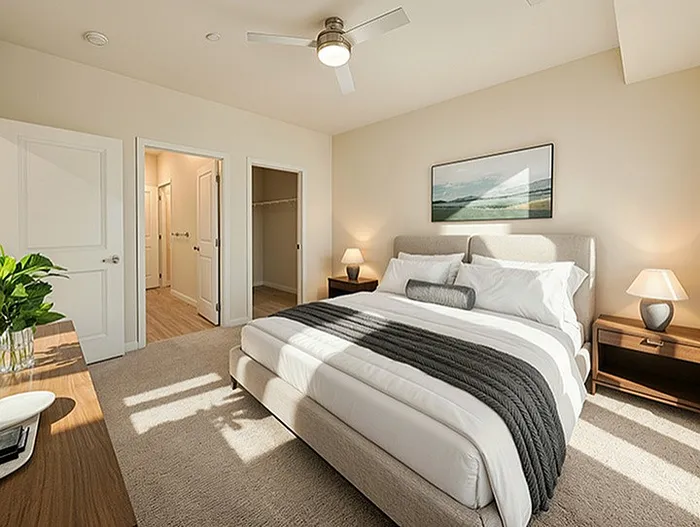 Inviting bedroom with a plush bed, modern decor, and natural light streaming through a window, creating a serene and cozy ambiance.
