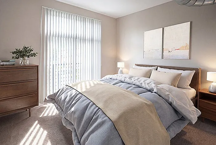 Bright and inviting bedroom with a cozy double bed, modern decor, and natural light streaming through floor-to-ceiling windows.