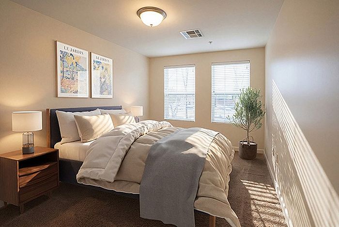 Cozy and inviting bedroom with soft lighting, featuring elegant decor and large windows for natural light.