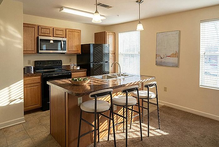 Inviting kitchen with modern appliances, cozy breakfast bar, and plenty of natural light.