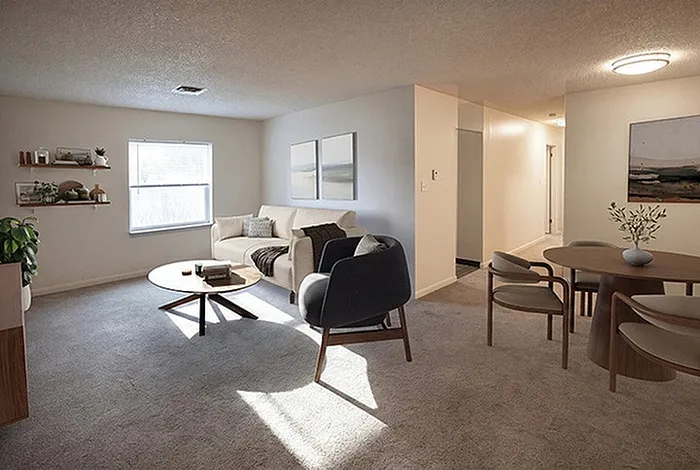 Bright and inviting living space with modern decor, featuring a cozy seating area and stylish dining set.