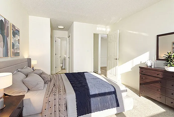 Bright and inviting bedroom with elegant decor, featuring a plush bed, chic furniture, and abundant natural light.