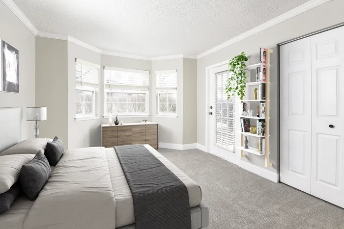 Bright and airy bedroom featuring elegant decor, plush carpeting, and large windows with a serene view.