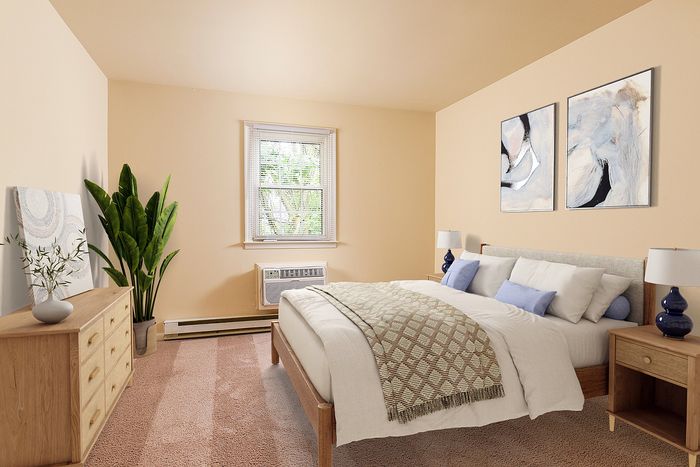 Inviting bedroom with cozy decor, featuring a comfortable bed, elegant artwork, and lush greenery for a serene atmosphere.