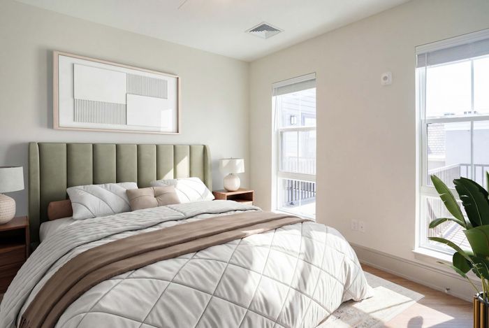 Bright and airy bedroom with a plush green headboard, cozy bedding, natural light, and modern decor.