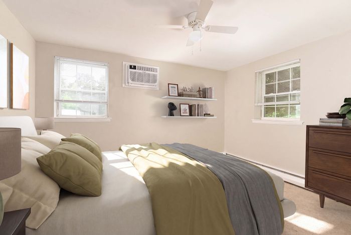 Inviting bedroom with plush bedding, natural light streaming through windows, and elegant decor featuring floating shelves and a chic dresser.