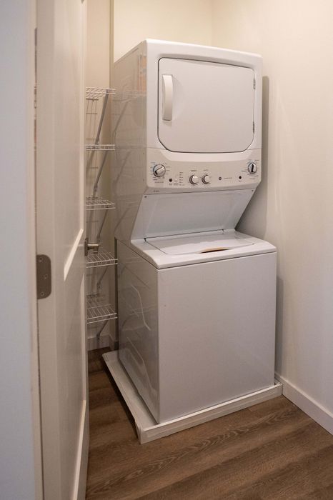 Chic in-apartment laundry setup with a modern stacked washer and dryer, offering convenience and style.