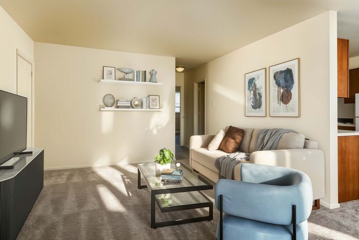Inviting living room with modern decor, cozy seating, and ample natural light, perfect for relaxation.
