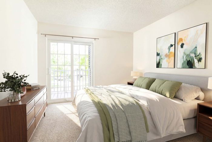 Bright and airy bedroom with modern decor, featuring a comfortable bed, elegant wooden dresser, and large windows leading to a sunny balcony.