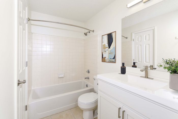 Bright and modern bathroom with a sleek vanity, elegant tilework, and contemporary accents creating a serene atmosphere.