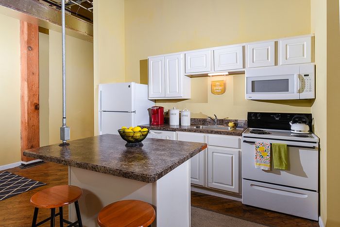 Charming kitchen with modern appliances, cozy island seating, and warm accent lighting.