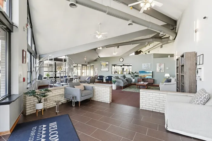 Modern and inviting communal lounge area with plush seating, stylish decor, and ample natural light, perfect for relaxation and social gatherings.