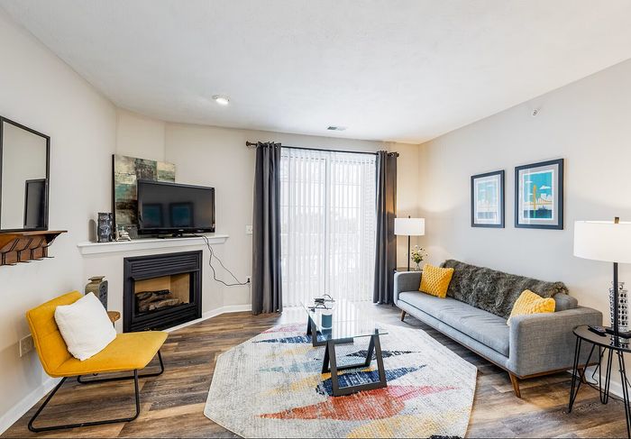 Bright and modern living room with ample natural light through large windows.