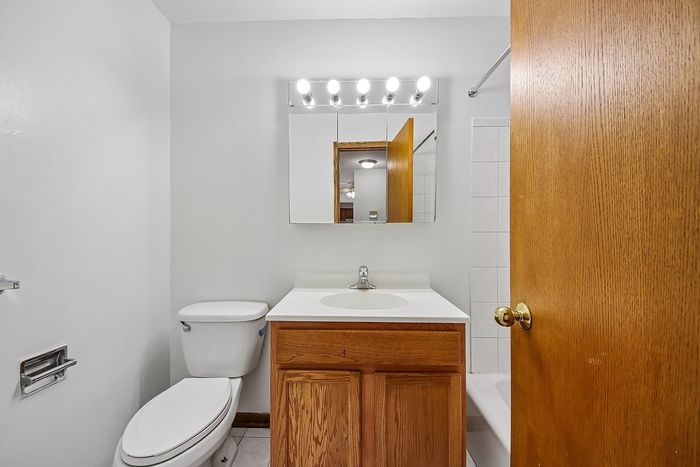 Cozy bathroom with a sleek vanity, ambient lighting, and a modern white toilet. Perfect for a stylish touch in your new home.