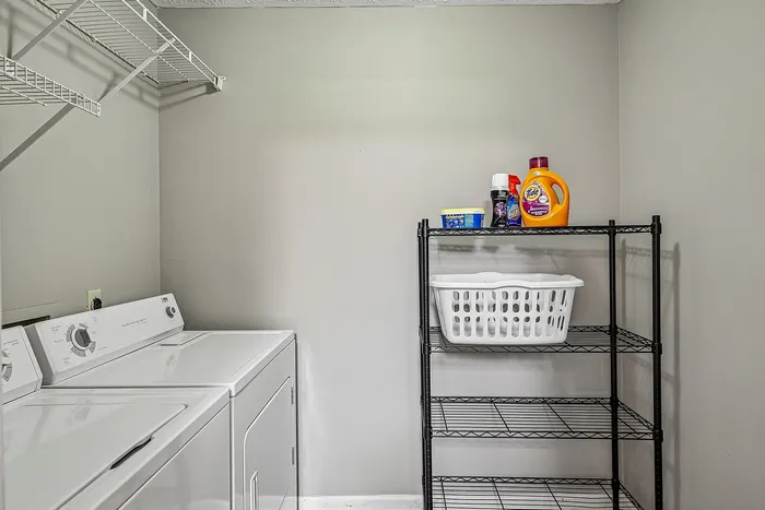 Contemporary laundry room with modern washer, dryer, and ample storage space for a streamlined living experience.