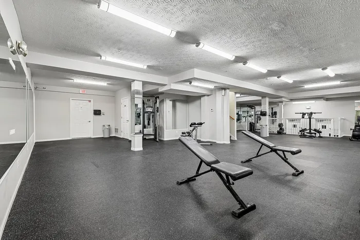 Spacious and well-equipped fitness center with modern exercise equipment, ideal for an active lifestyle.