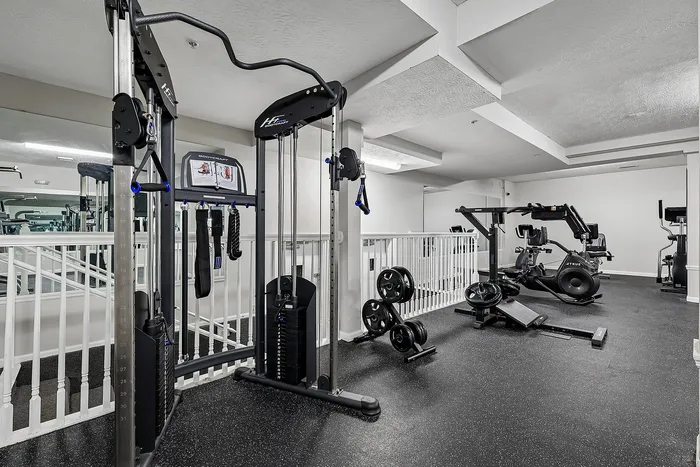 Modern fitness center equipped with weight machines, exercise bikes, and a sleek design for an energizing workout experience.