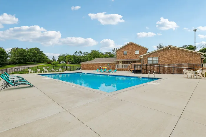 Inviting outdoor swimming pool area with sun loungers and scenic green views perfect for relaxation.