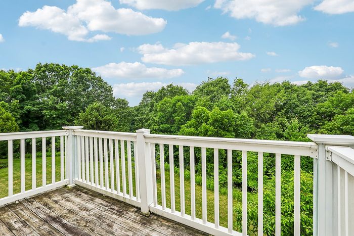 Charming balcony view overlooking lush greenery, perfect for relaxation and enjoying nature.