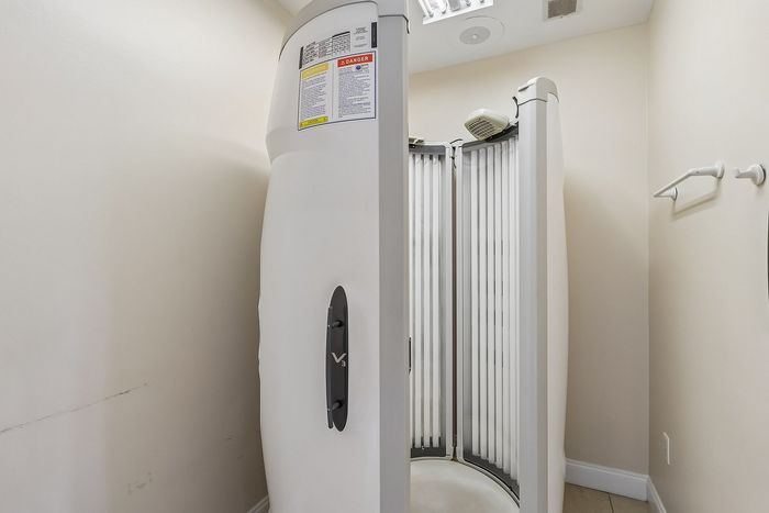 Modern in-home tanning capsule providing a sleek and private tanning experience, ideal for personal wellness in stylish apartments.