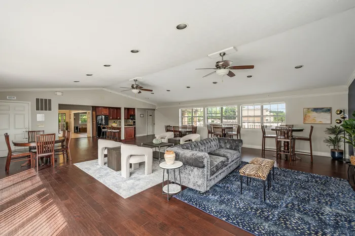 Spacious and elegant living area with plush seating, hardwood floors, and abundant natural light, perfect for relaxation and entertaining.