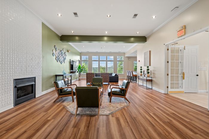 Inviting modern living room with elegant fireplace, stylish seating, and expansive windows offering natural light and scenic views.