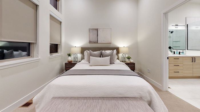 Bedroom on the second floor with high ceilings, large windows for lots of light, and attached bathroom