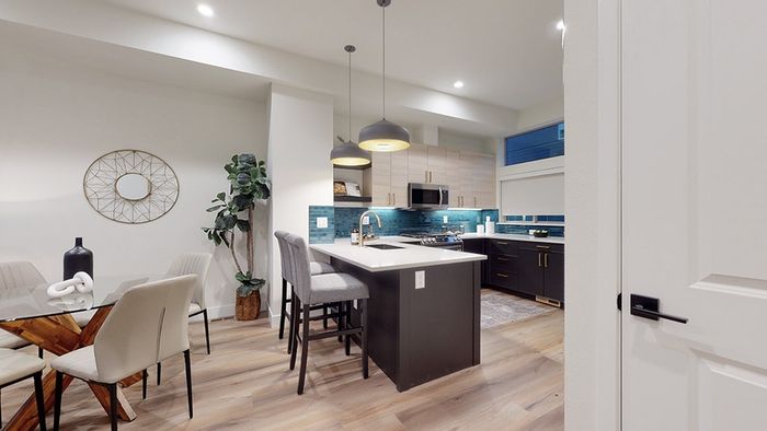 Modern kitchen with island connected to dining area