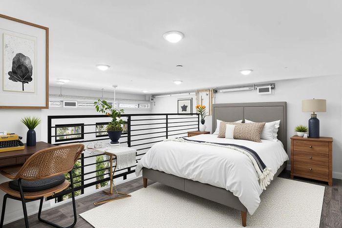 Bright and modern loft bedroom with stylish furniture, wall art, and charming decor, featuring natural light and cozy ambiance.