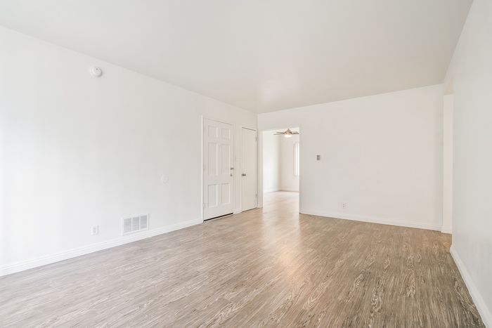 Bright and airy living room with elegant wood flooring and a modern, minimalist design.
