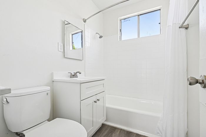 Bright and modern bathroom featuring sleek fixtures, spacious bathtub, and elegant tile accents.