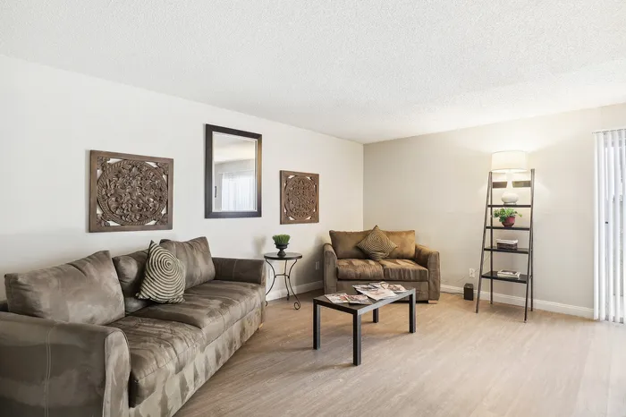 Inviting living room with plush couches, chic decor, and ambient lighting, perfect for relaxation and entertaining.