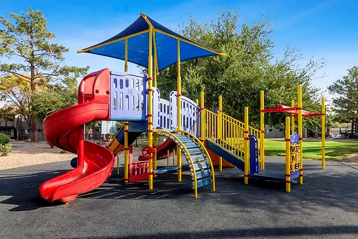 Vibrant playground with colorful slides and climbing structures, perfect for family-friendly communities.